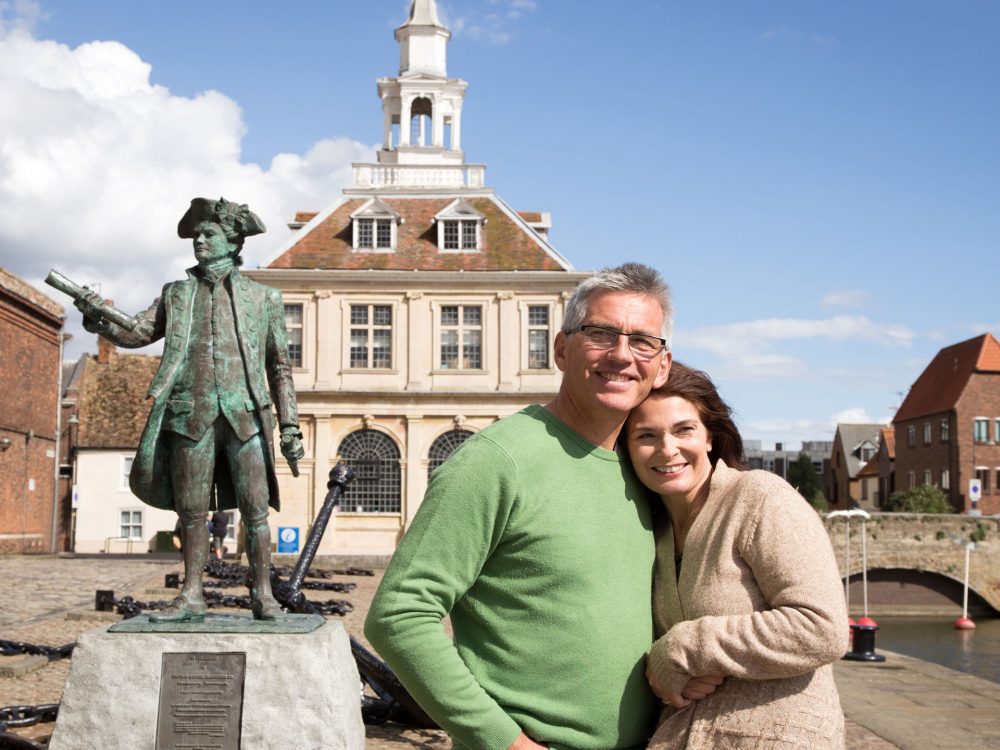 A couple pointing at artwork inside a gift shop in west Norfolk.