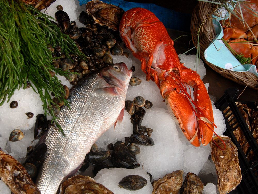 A couple pointing at artwork inside a gift shop in west Norfolk.