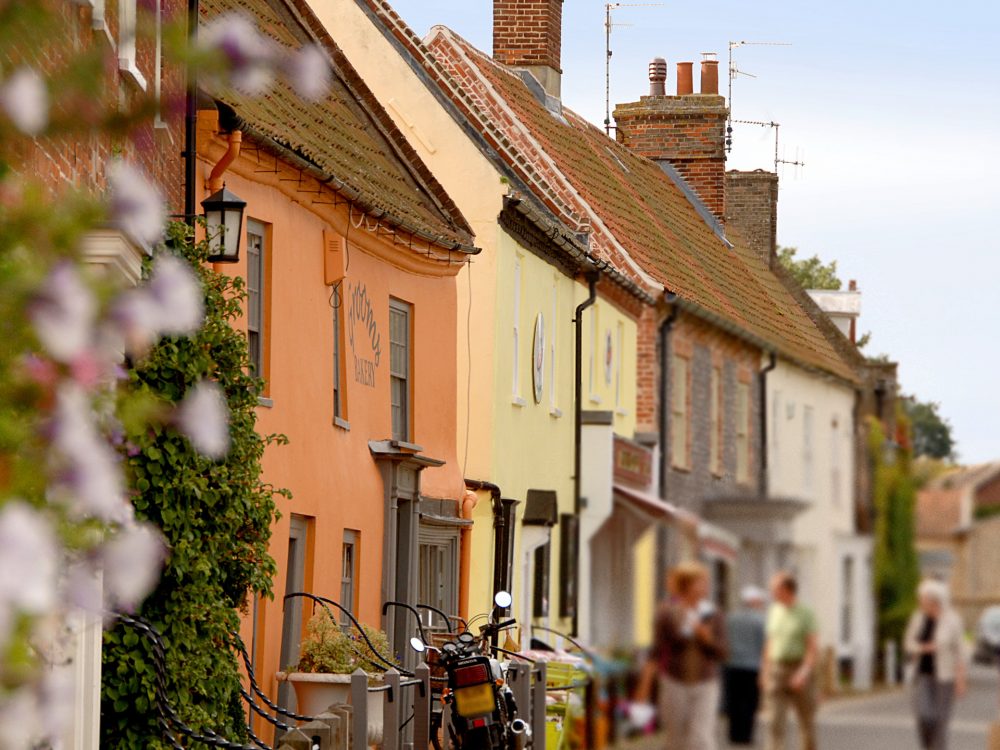 A couple pointing at artwork inside a gift shop in west Norfolk.