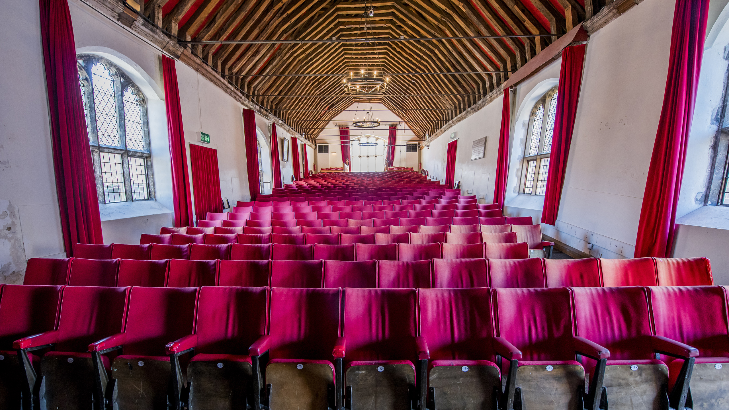 Red empty seats lined up inside St George's Guildhall in King's Lynn.