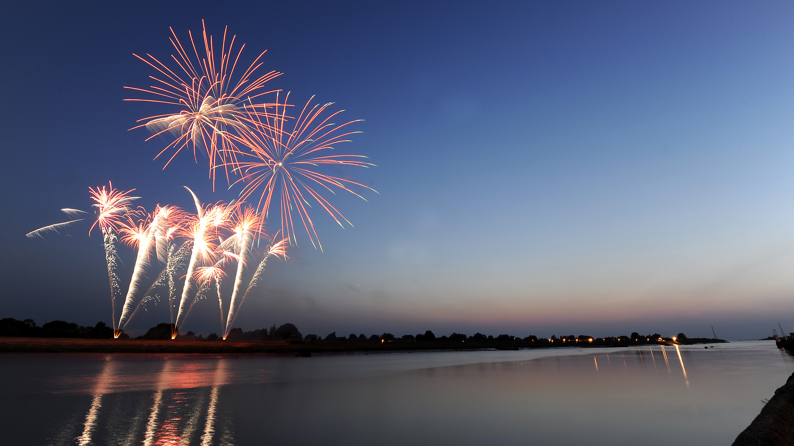 Fireworks in the night sky reflecting onto the water. The shot was taken from South Quay in King's Lynn.
