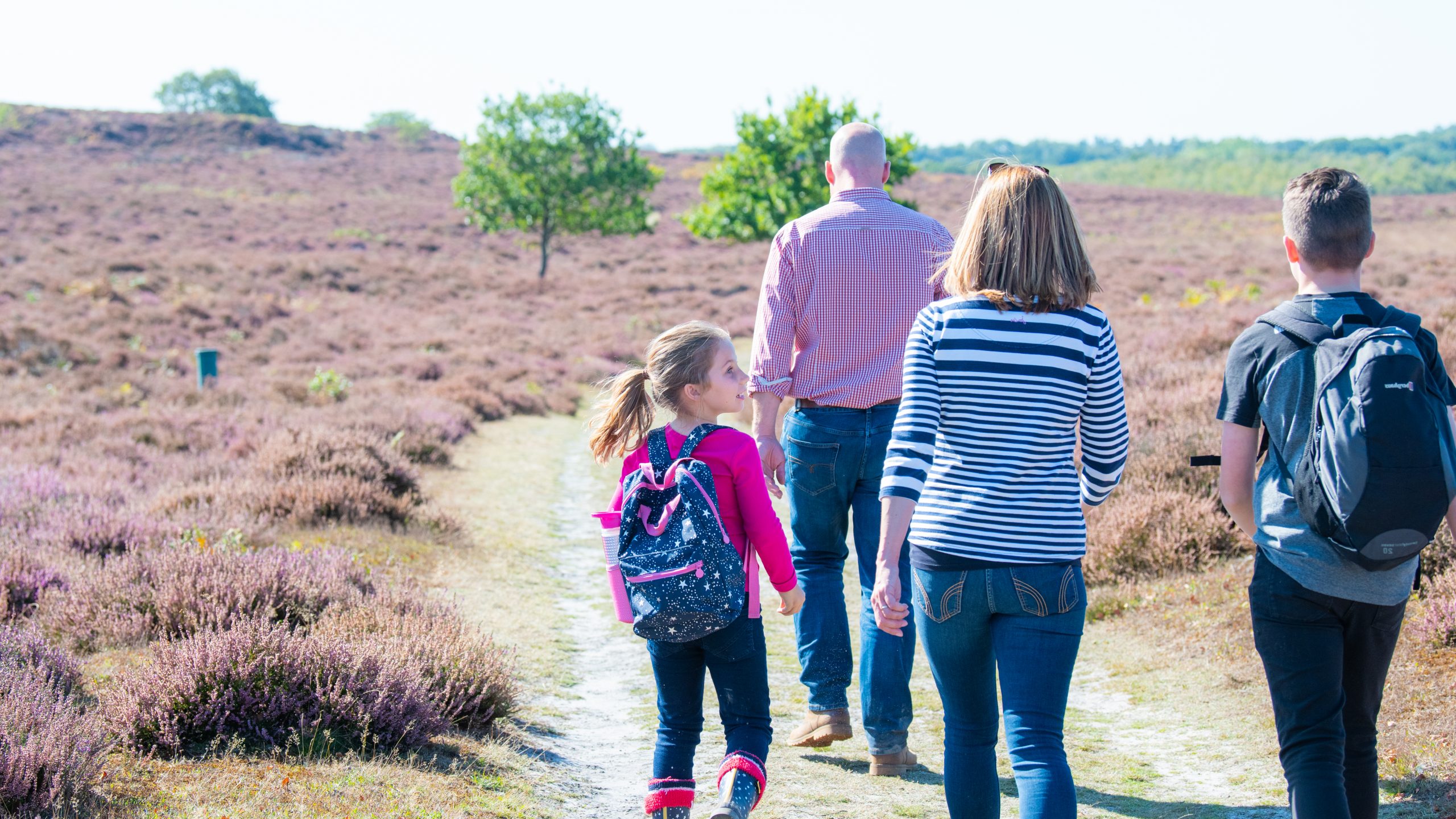 A family of four walking through Grimston Warren.