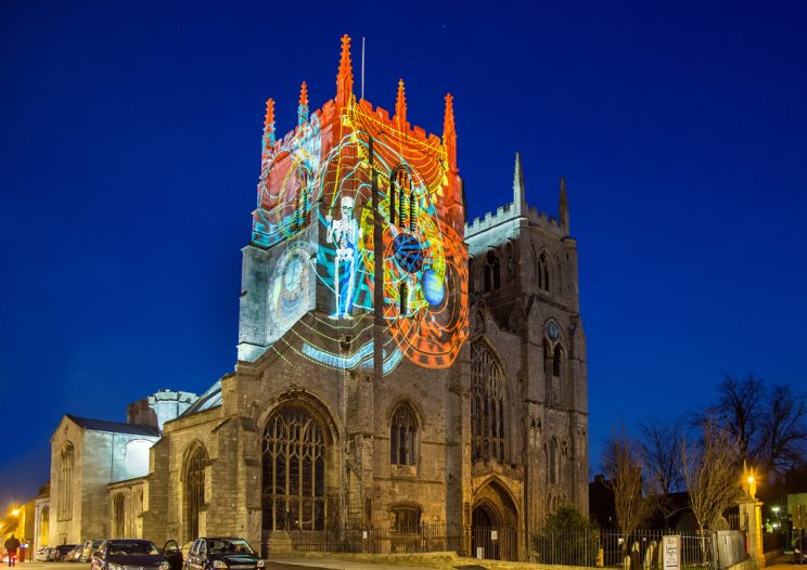 King's Lynn Minster lit up with illuminations during the night.