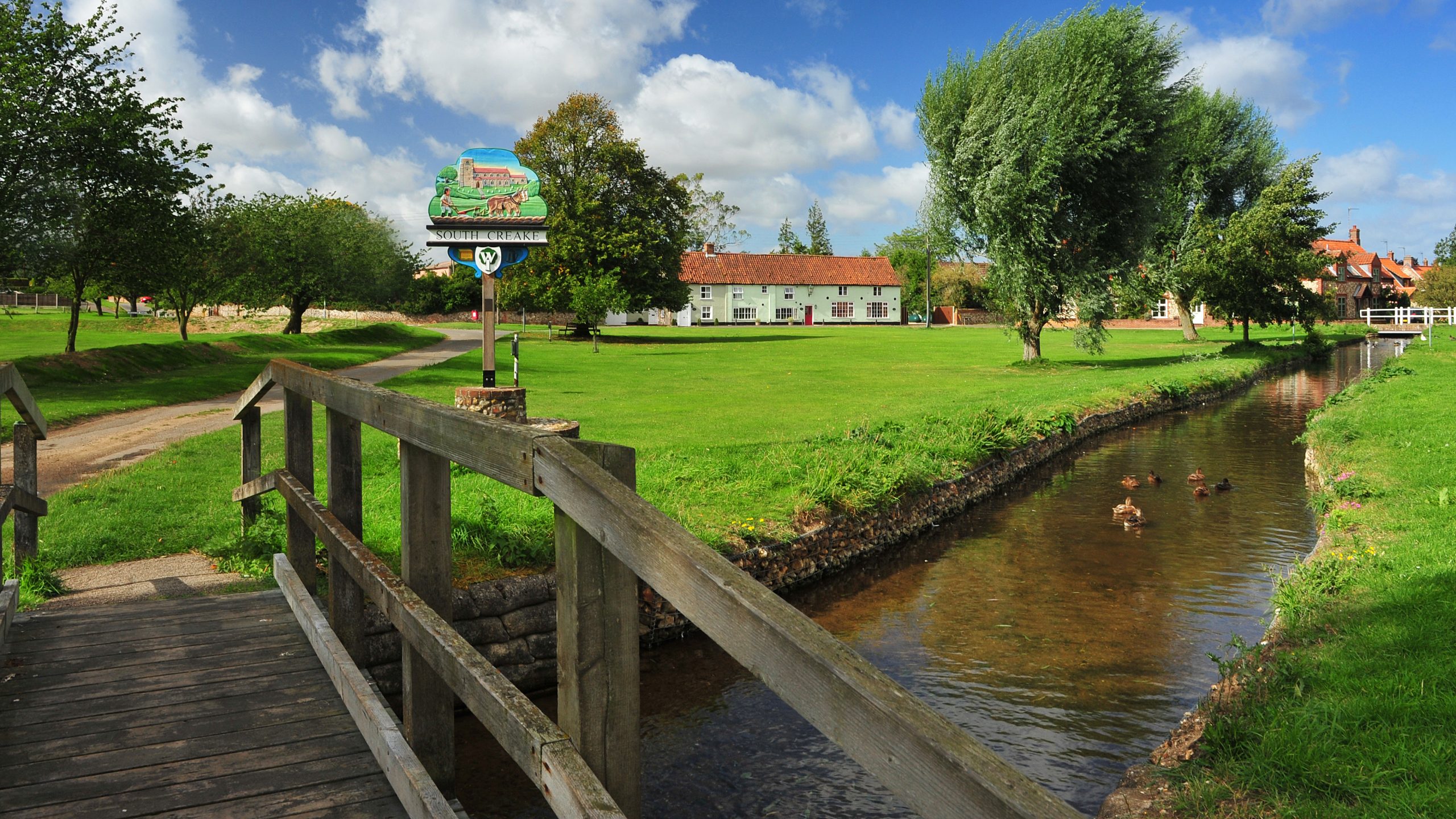The wooden bridge and village sign at South Creake.