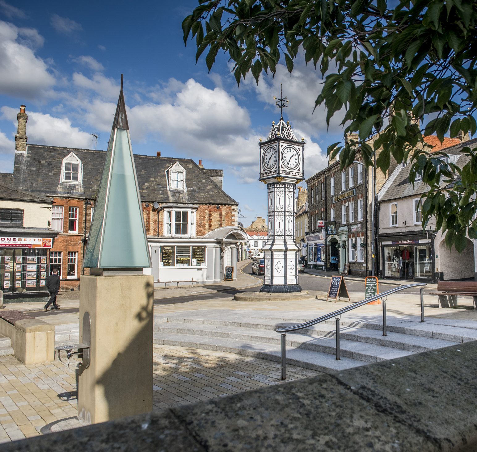 Downham Market town centre with Downham Market's black and white town clock in the town square.