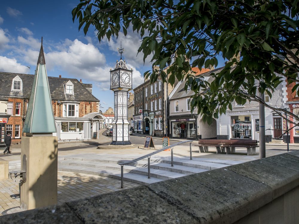 A shot of Downham Market's black and white town clock.