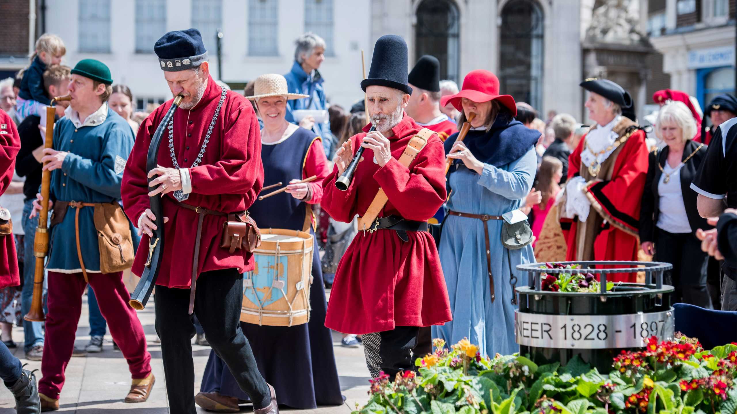 A group of performers playing traditional instruments and wearing traditional hanseatic outfits on Tuesday Market Place.