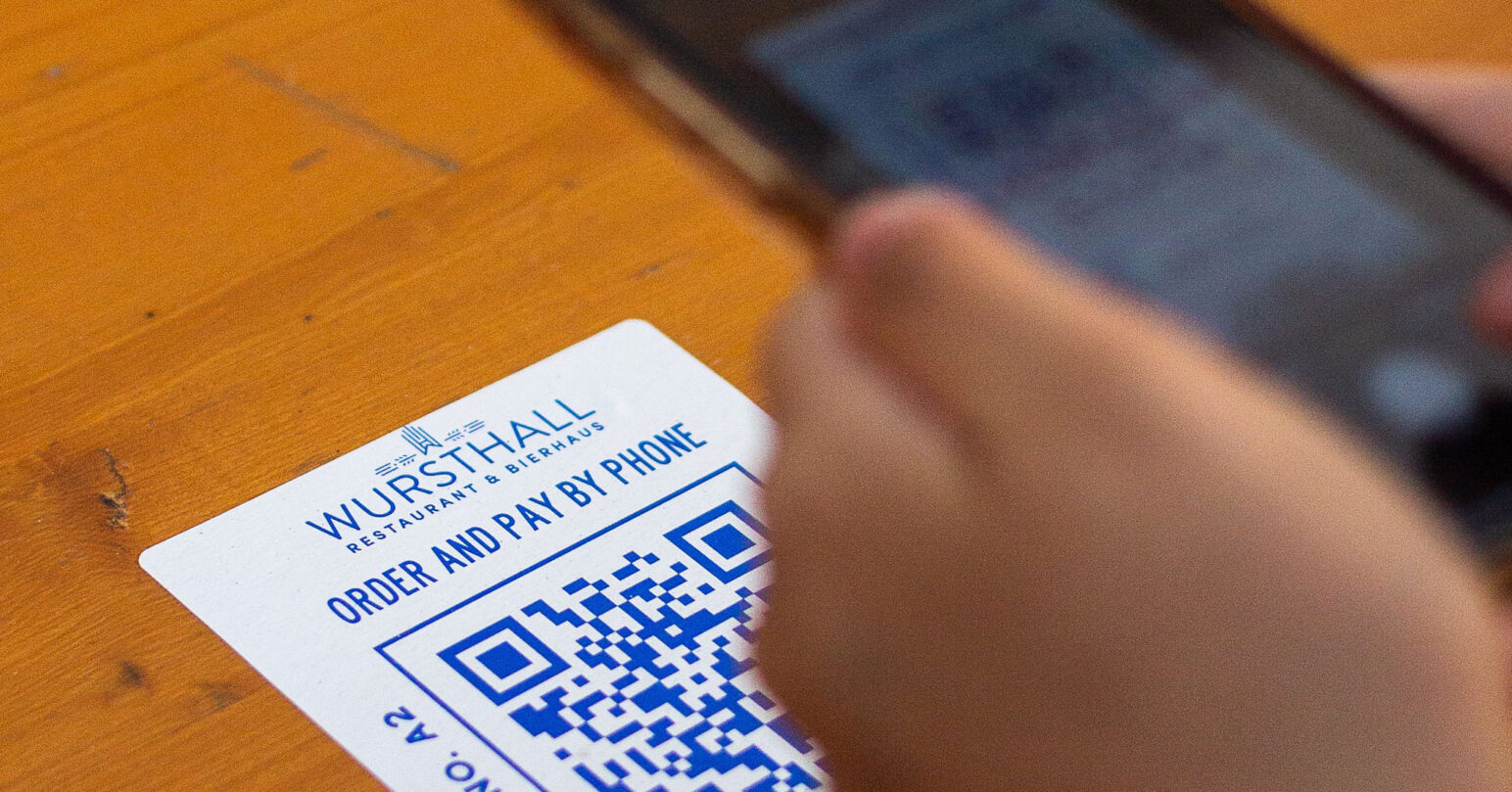 A person scanning a QR code on their phone