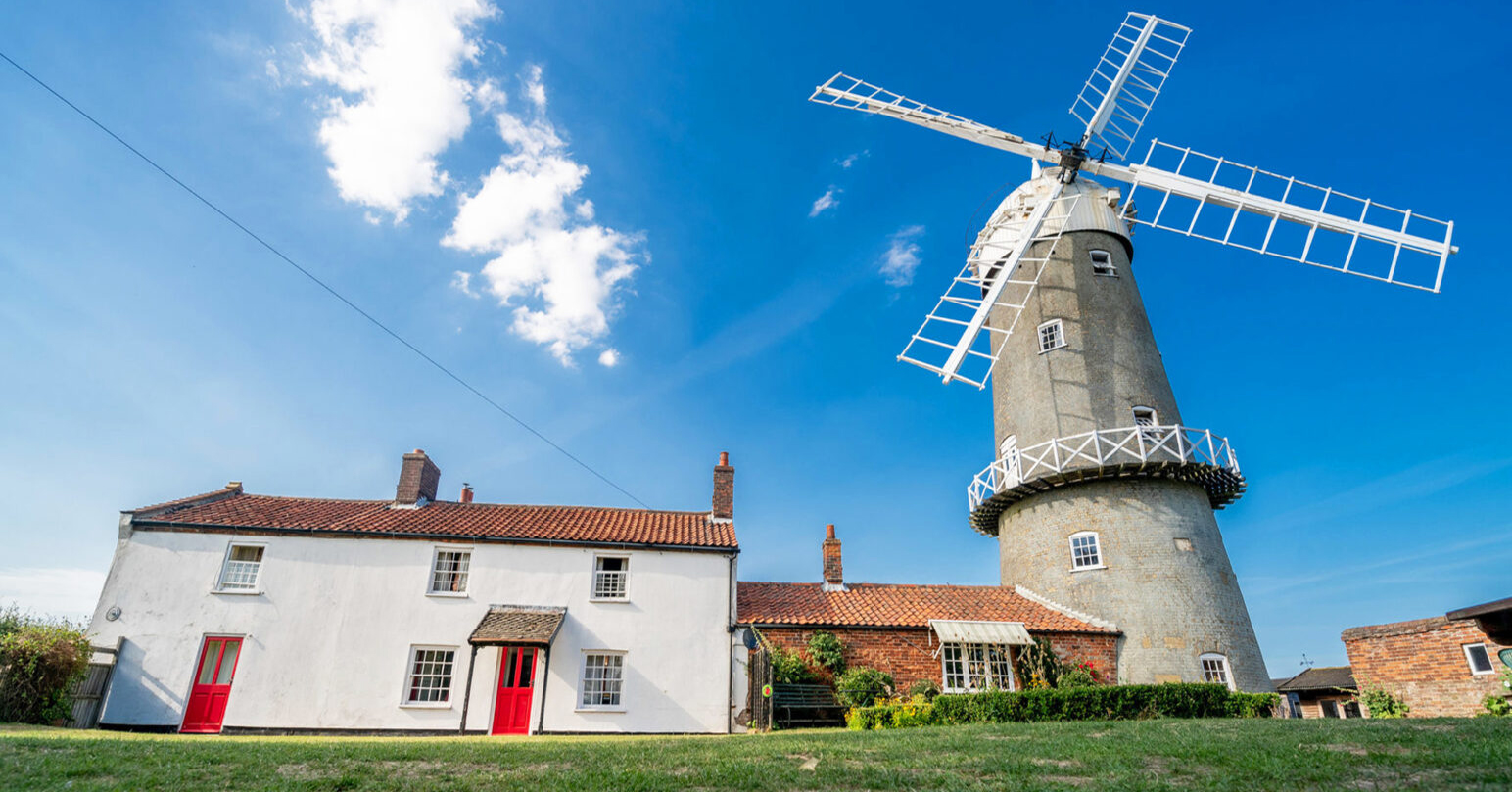 Bircham Windmill on a sunny day with clear blue skies.