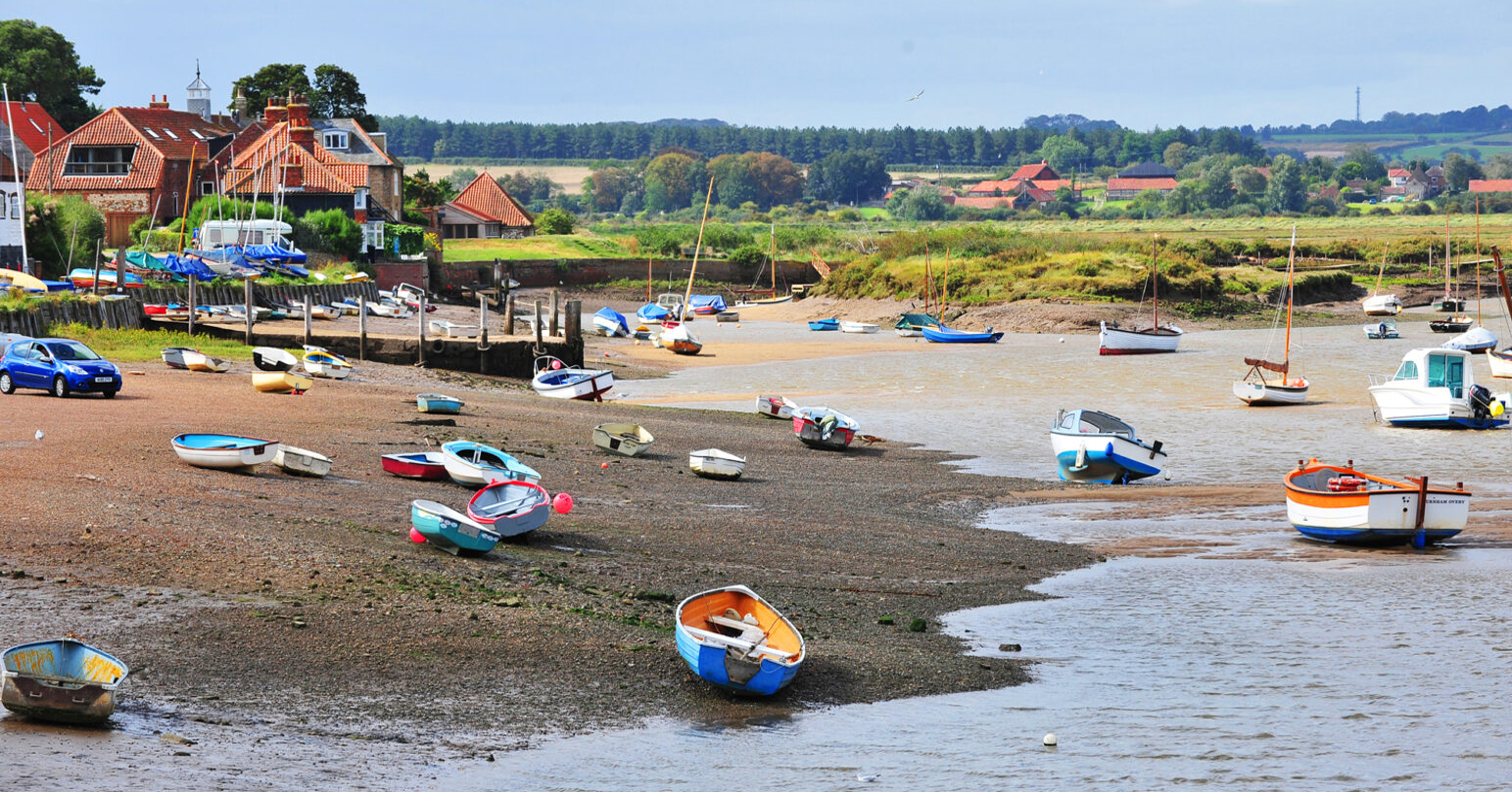 Colourful boats moored at Burnham Overy Staithe in West Norfolk