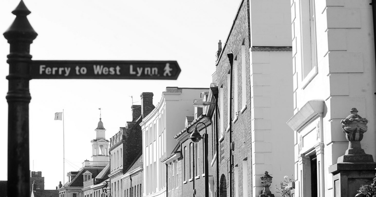 A black and white image of King Street in King's Lynn. In the background you can see the famous Custom House building.