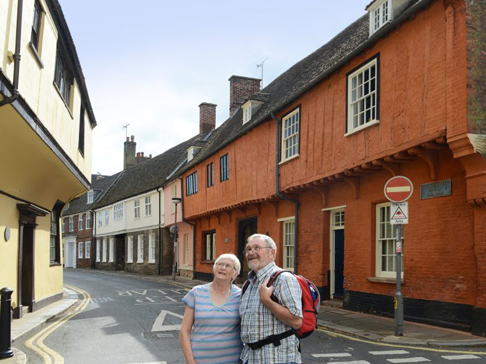Elderly couple walking down Nelson Street in King's Lynn, West Norfolk.