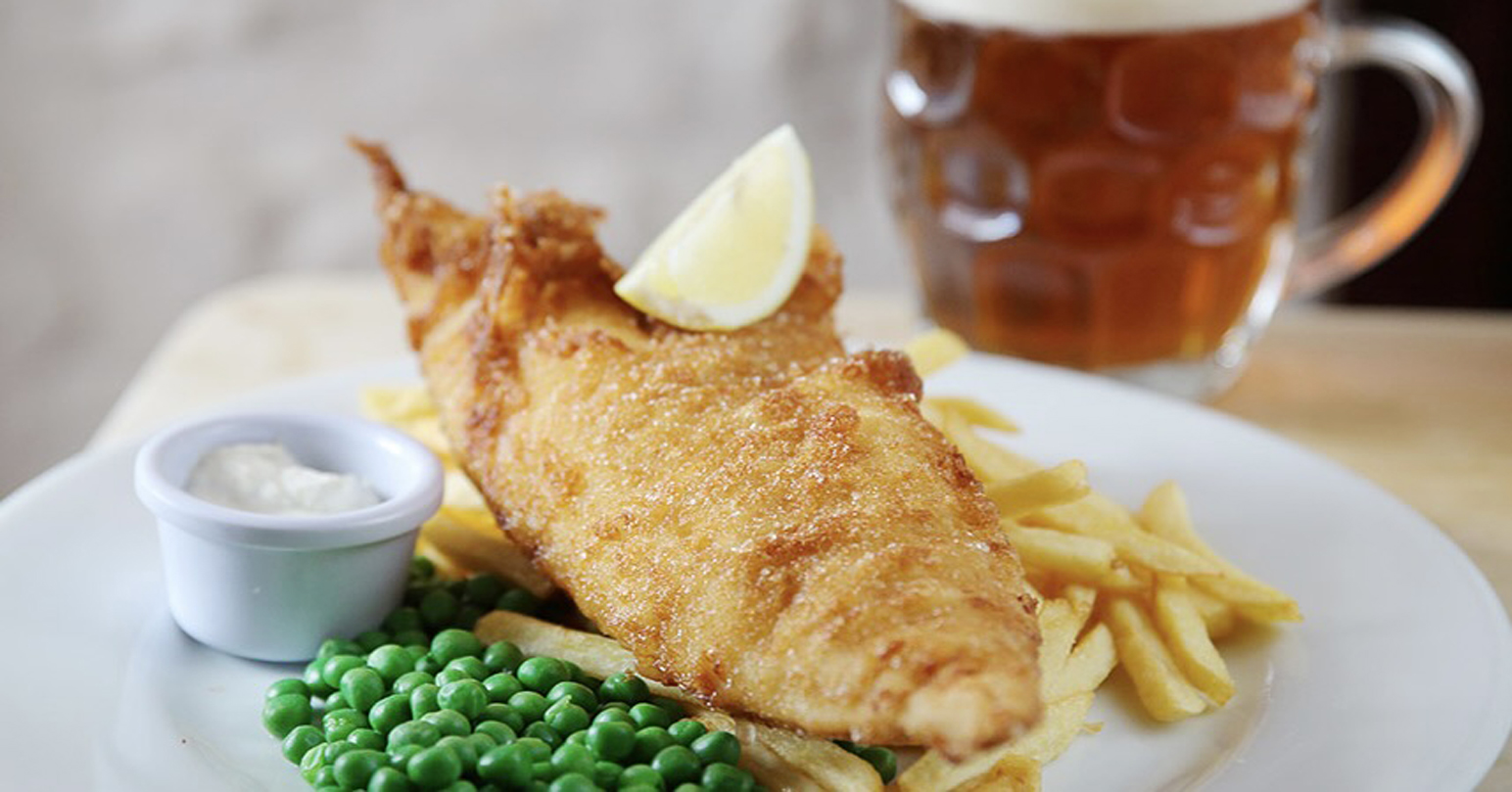 Freshly battered fish and chips served with a pint at The Jolly Sailors in West Norfolk.