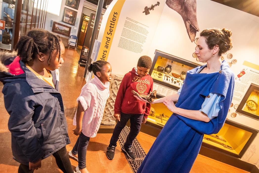 A group of children learning about the romans at Lynn Museum, West Norfolk.