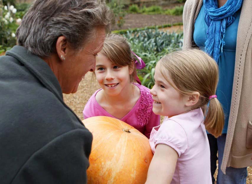 A child holding a large pumpkin at Oxburgh Estate, West Norfolk.