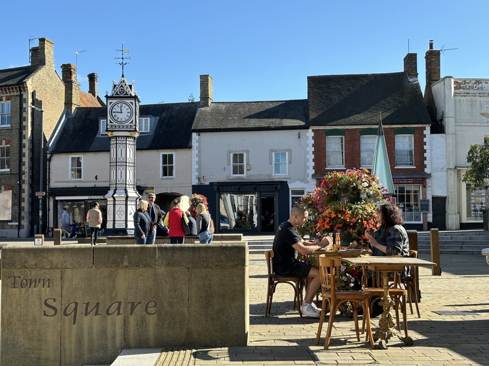 A couple pointing at artwork inside a gift shop in west Norfolk.